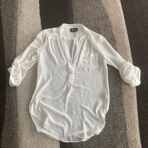 By by white long sleeve shirt